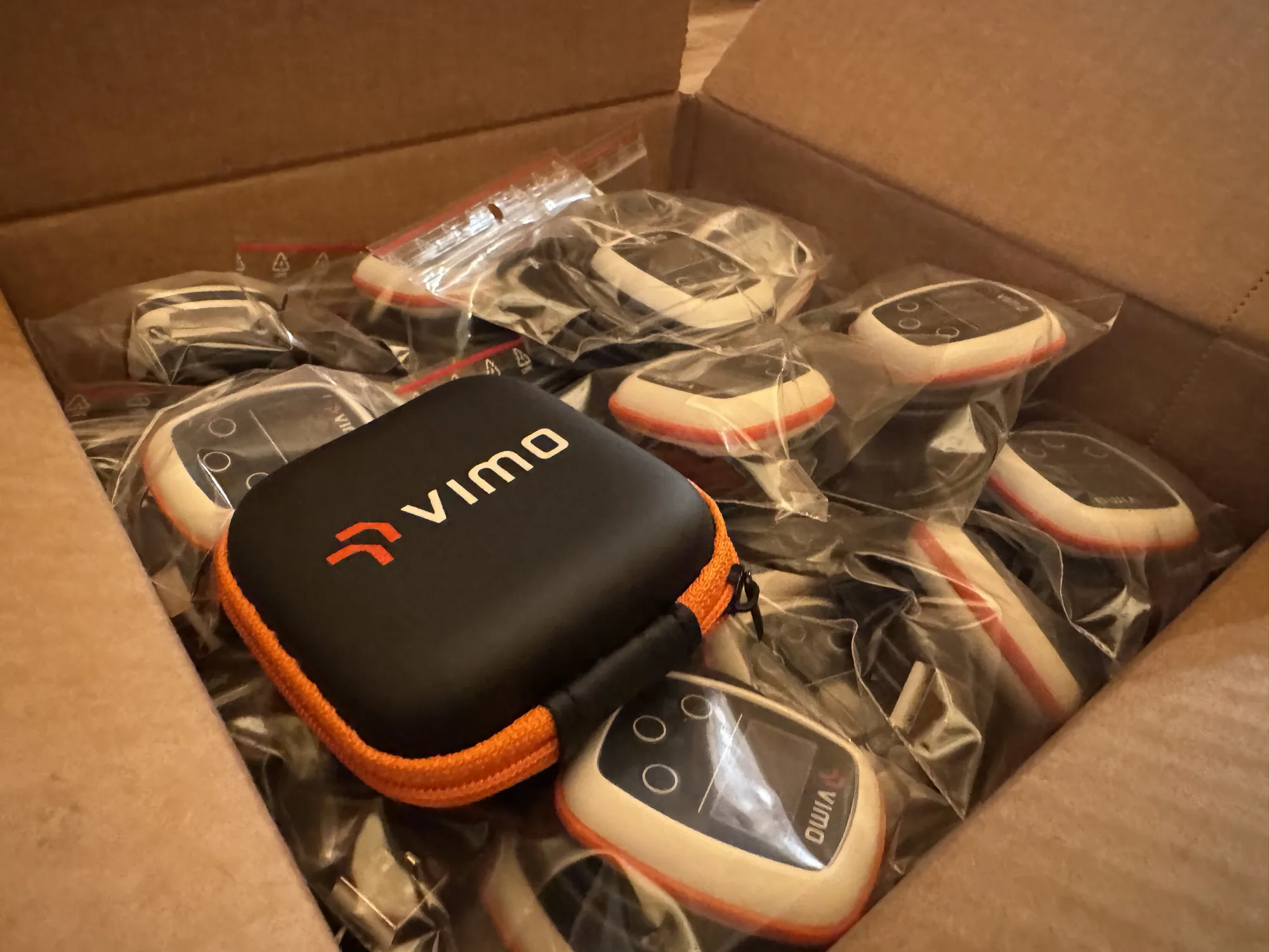 A Vimo case sitting on a box of bagged devices ready to ship